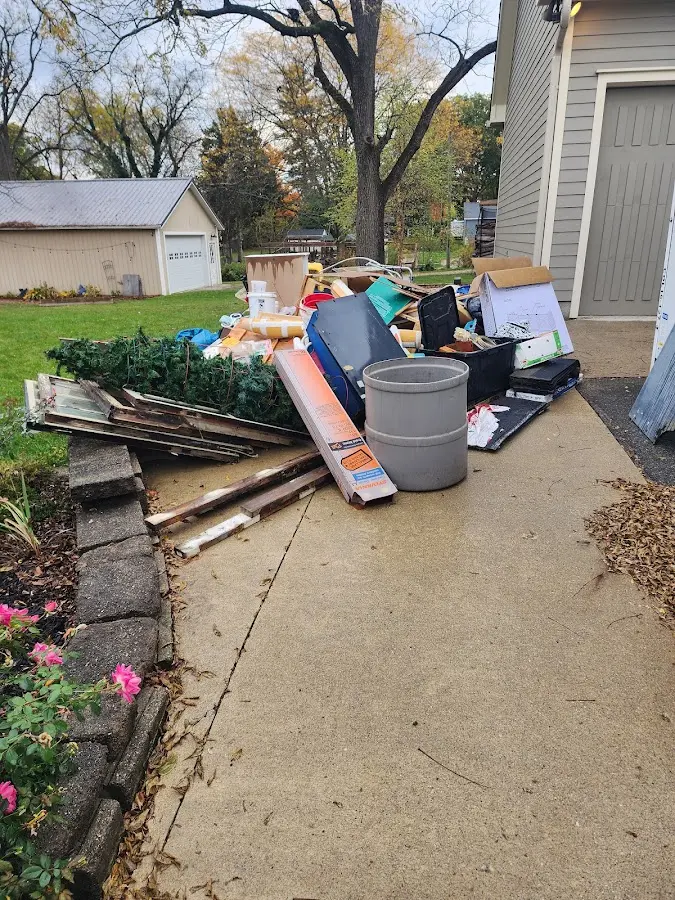 Dumpster being loaded with debris for Estate Cleanout Dumpster Rental in Hibbing